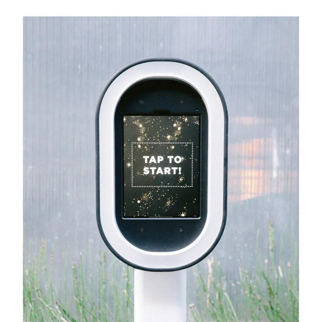 Photo booth screen reading Tap to start, set up outdoors