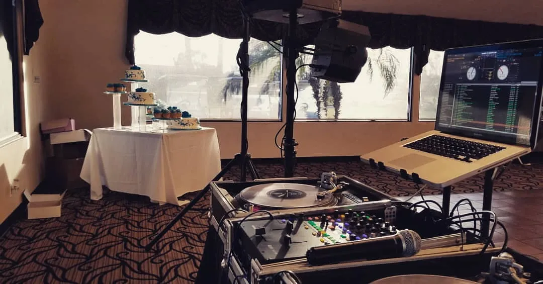 Dessert table and DJ rig set up in a hotel ballroom