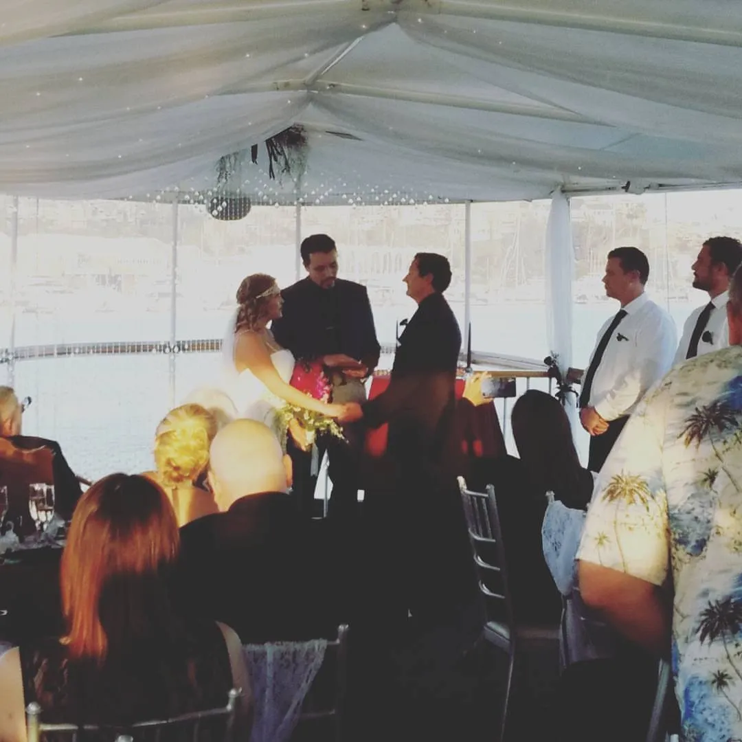 Guests mingling under a white event tent