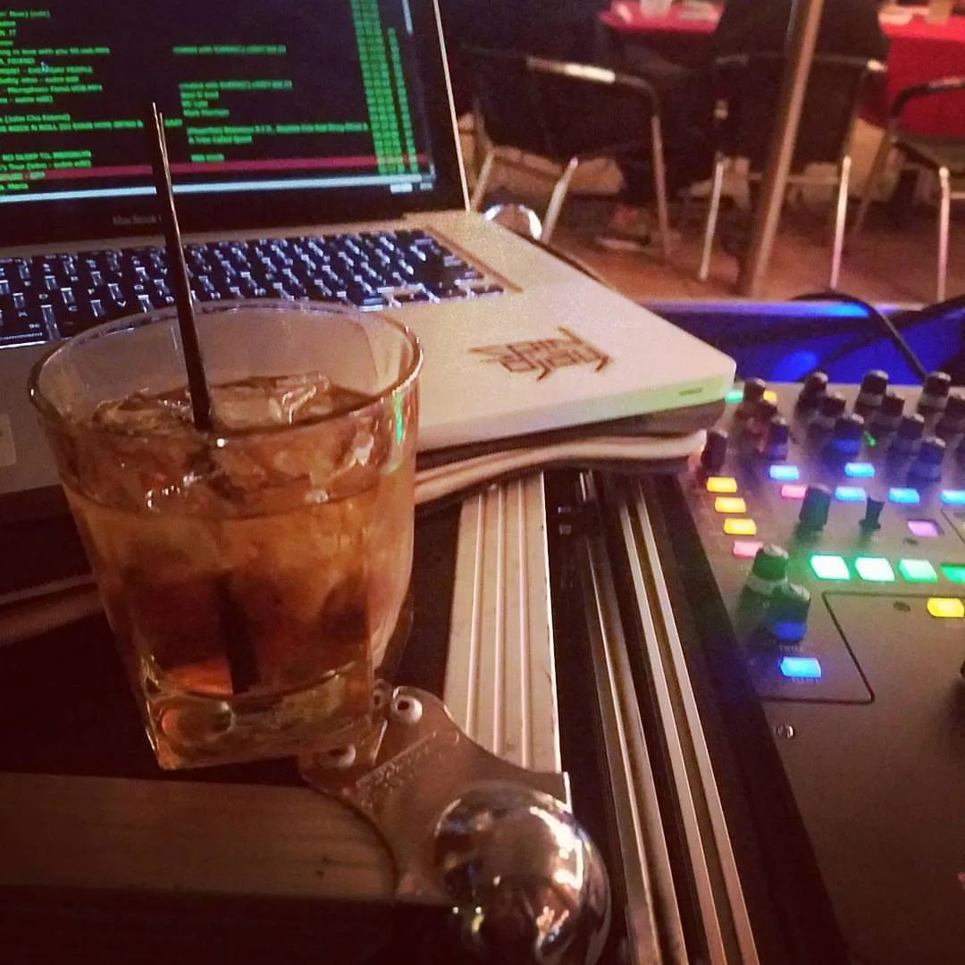 Drink resting beside the controller during a bar residency